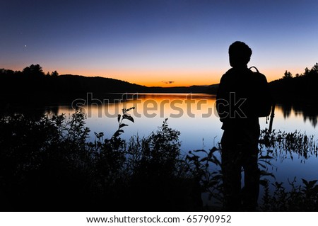Man gazing out at the night sky shortly after sunset.