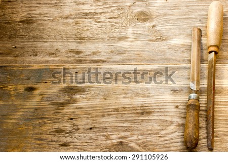 various different steel retro rusty rasp file tool collection isolated on wooden background. Copy space to right.