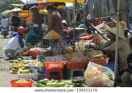 PHU QUOC, VIETNAM - FEB 17: Local farmers selling fresh produce at the farmer market on February 17, 2013 in Phu Quoc, Vietnam. This market is held daily and is the biggest on the island.