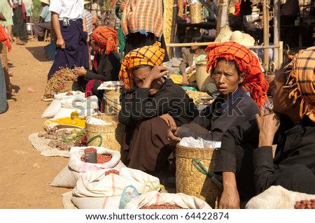 NYAUNG SHWE, MYANMAR - OCT 15:  Local residents  sell fresh products at  the friday market on Oct 15, 2010 in Nyaung Shwe, Lake Inle, Myanmar. This market is a melting pot of seven local minority groups.
