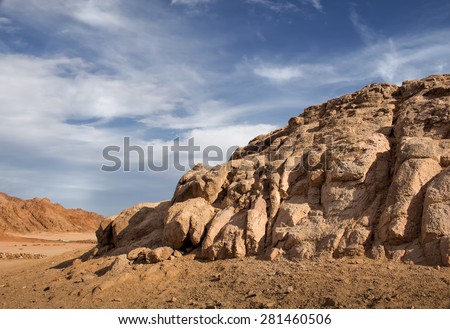 Rocks in the desert, Egypt Landscape in the desert in Egypt. Small rocky hills. Blue sky with white clouds.