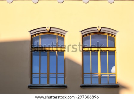 Two Windows in Yellow Couple of windows, same like a twins. Yellow frame and yellow facade. Interesting details in Art Deco style. Located in Bratislava, Slovakia.