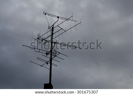 Antenna and Cloudy Sky\
Silhouette of a big antenna. Cloudy rainy grey sky in the background.