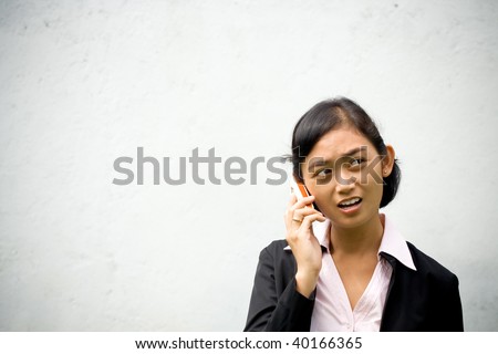 asian business woman having a serious business phone call