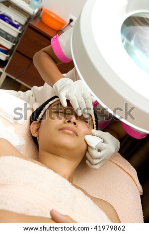 blackhead cleansing on woman face during facial treatment at beauty clinic