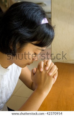 portrait of asian young woman praying in church
