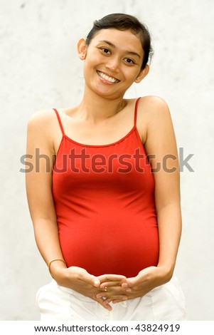 portrait of asian woman happy about her pregnancy