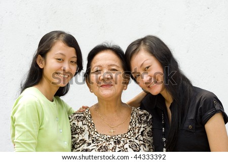 portrait of asian happy family embracing each other, grandmother and two granddaughter