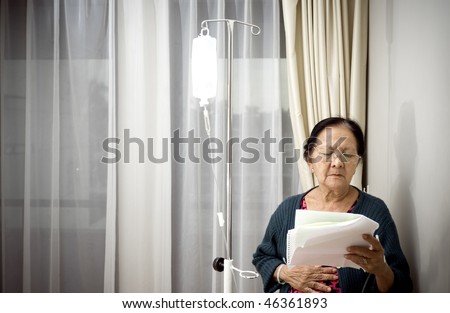 sick asian elderly woman during medication and inpatient treatment at the hospital. worried reading laboratory test result