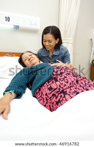 daughter accompany sick old mother in the hospital