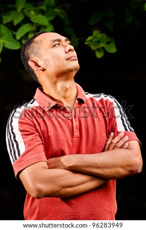 portrait of healthy and fit asian ethnic young adult male look up confident