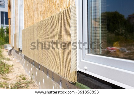 Closeup view on house wall with plastic window and insulation panels