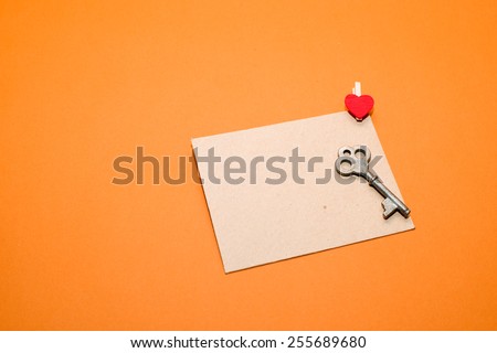 Mailing Envelope with heart and  key on a orange background.