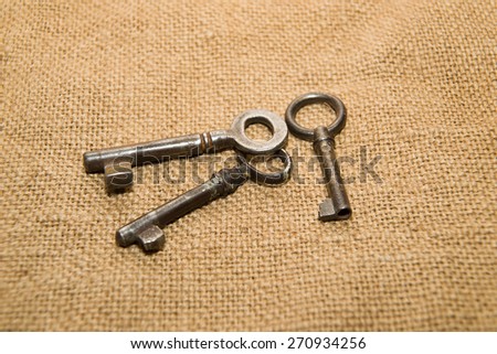 Three vintage keys to the safe on old cloth