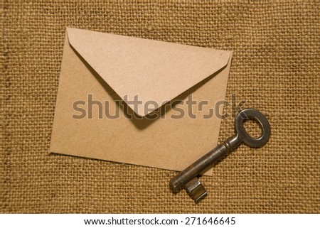 Vintage key and envelope for letters on the old cloth