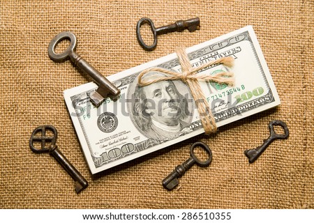 One pack of dollars tied up with rope and keys  in the old cloth