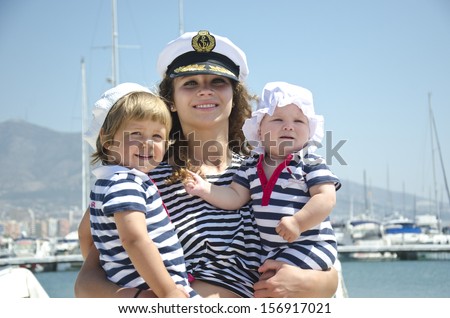 Adorable woman wearing sea Captain\'s cap and sexy sailor T-shirt