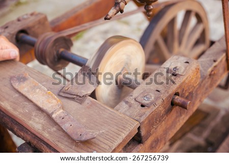 Antique frame with grinding wheel for sharpening knives in medieval times