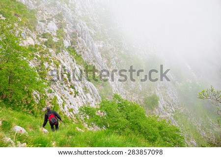 A climber, backpacker, descends into the canyon that led him down the road of marble, covered since Roman times by the quarrymen.