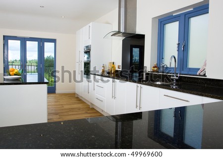 An brand new open plan kitchen and dining area in a large contemporary property