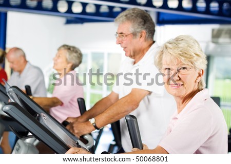 Group of older mature people exercising in the gym