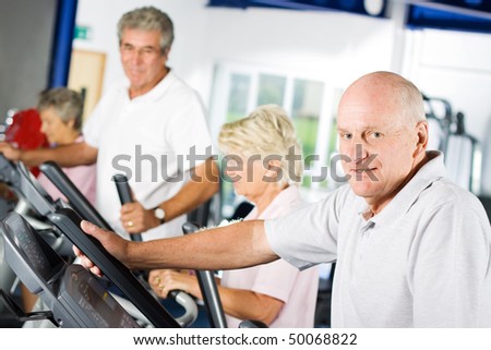 Mature older man exercising in the gym