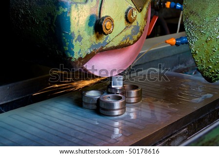 Filing down stainless steel parts using semi-automated machinery