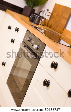 Modern designer kitchen with cool black cooker and hob