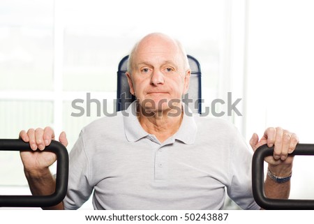 Mature older man working out in the gym