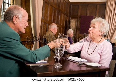 Mature older couples enjoying a celebration in a restaurant