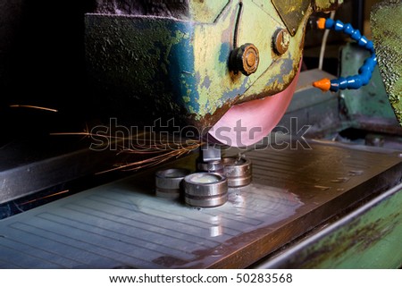 Filing down stainless steel parts using semi-automated machinery