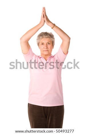 Mature older lady in yoga position, isolated on white background