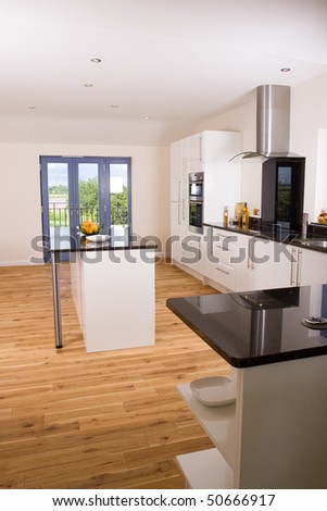 An brand new open plan kitchen and dining area in a large contemporary property