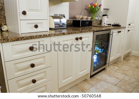 Designer modern kitchen interior with granite worktop and cream units