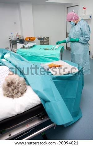 Surgical team performing operation on patient in modern theatre