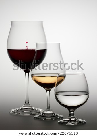 Glasses with red wine, white wine and water