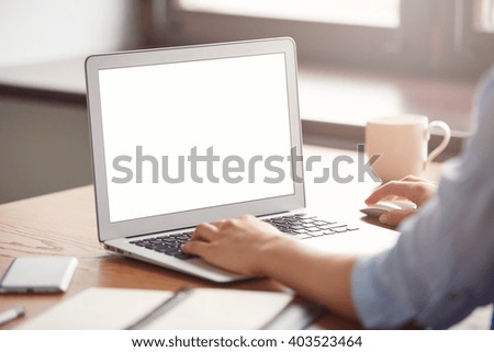 Cropped view of a young office worker sitting at table in cafe enjoying coffee after hard day at work. Female hands keyboarding on laptop with copy space for your text message or promotional content