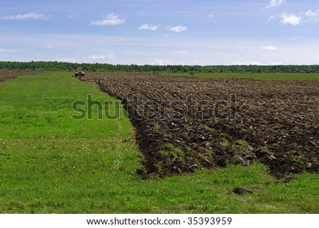 Cultivating of virgin soil (tractor ploughing new lands)
