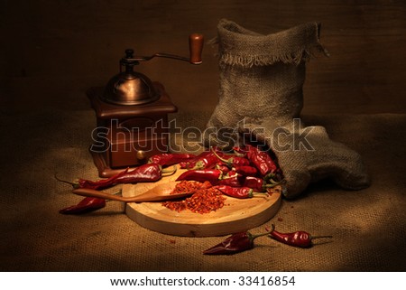 Vintage still life with cayenne pepper and handmill