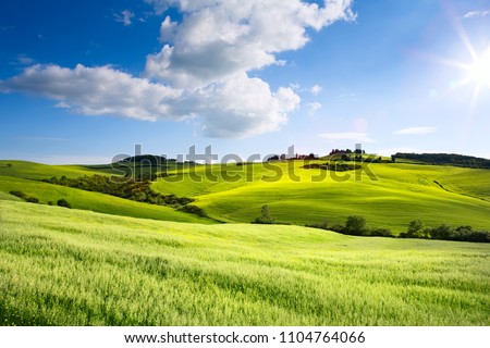 Italy countryside landscape with Tuscany rolling hills ; sunset over the farm land