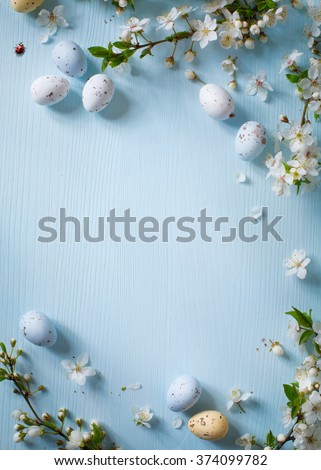 Easter eggs and spring flowers on wooden background