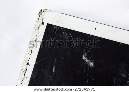Tablet with broken glass screen on white background.
