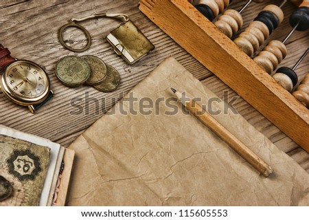 Old notes and coins and abacus on a wooden table