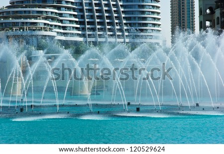 DUBAI, UAE - NOVEMBER 14: The Dancing fountains downtown and in a man-made lake in Dubai, UAE on November 14, 2012. The Dubai Dancing fountains are world\'s largest fountains with height 150 m.