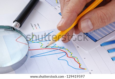 pencil  in hand and working paper chart