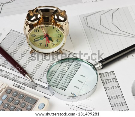 gold clock and office supplies on the table