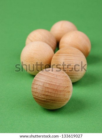 wooden geometric ball on a green background