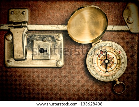 Old Suitcase And Compass Isolated On White Background