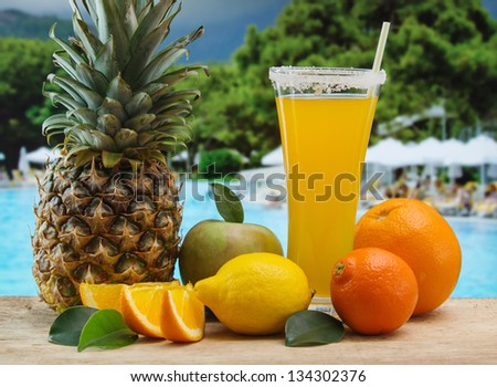 Glass of orange juice on a beach table Glass of orange juice on a beach table