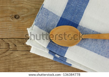 wooden kitchenware  and dishcloth on old wooden table